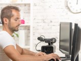 Foto di un uomo che usa il computer per fare video
